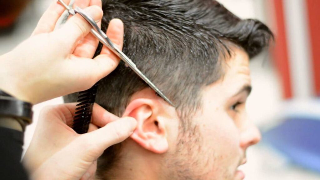 man getting a hair cut to maintain his hairstyle