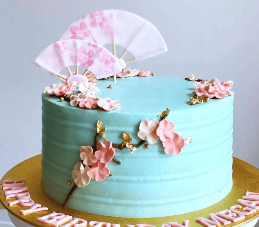blue cake with Chinese fan and flower petals, oriental Chinese customised cakes by spiffy cakes