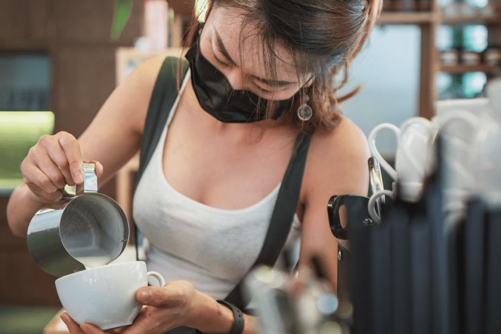 Barista pouring latte art at Neptune. Photo taken by @doggaebi