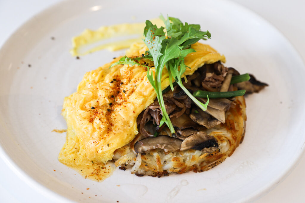 Knockhouse Cafe Duck Confit Hash- potato rosti, duck leg confit, scrambled eggs and hollandaise