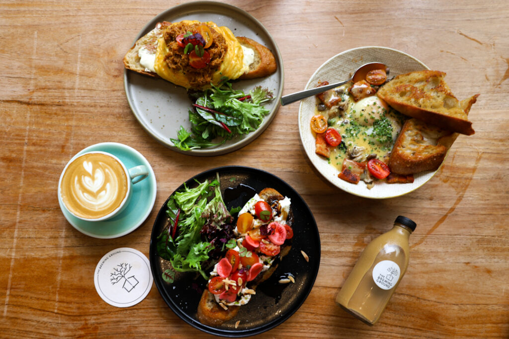 Flat lay of brunch dishes at The Brewing Ground, one of the best cafes in East Coast