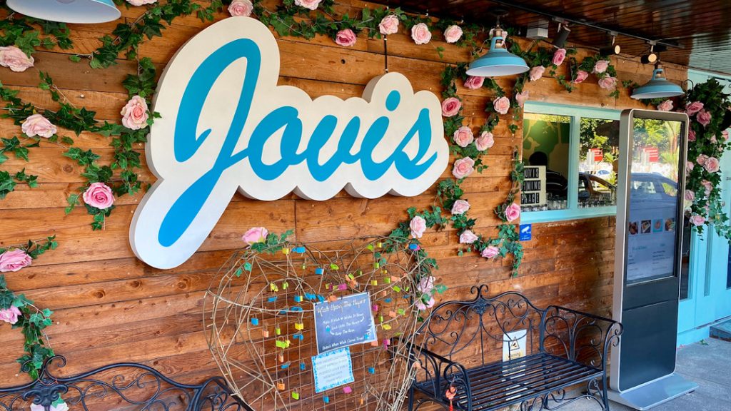 Heart railing and locks in the cafe front.