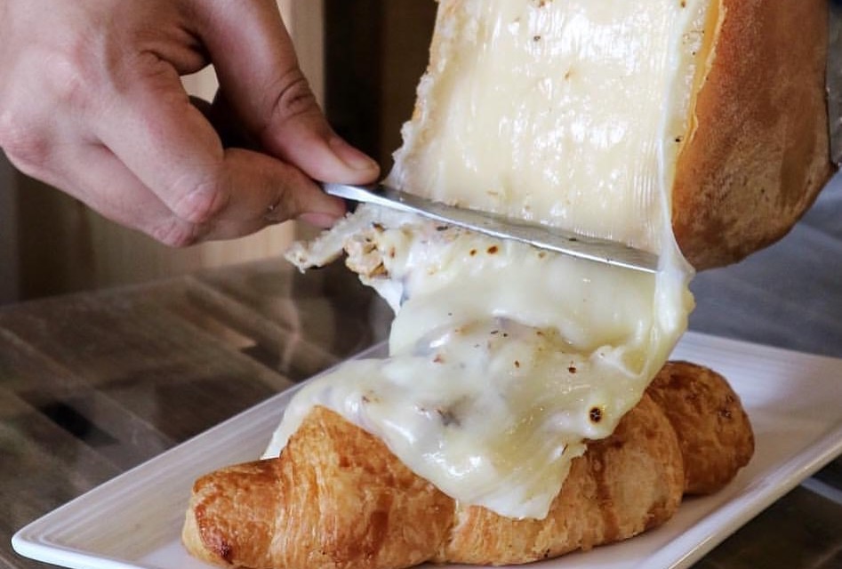 Melting Swiss Raclette Cheese on top of croissant, this cafe in Serangoon is known for their cheesy offerings