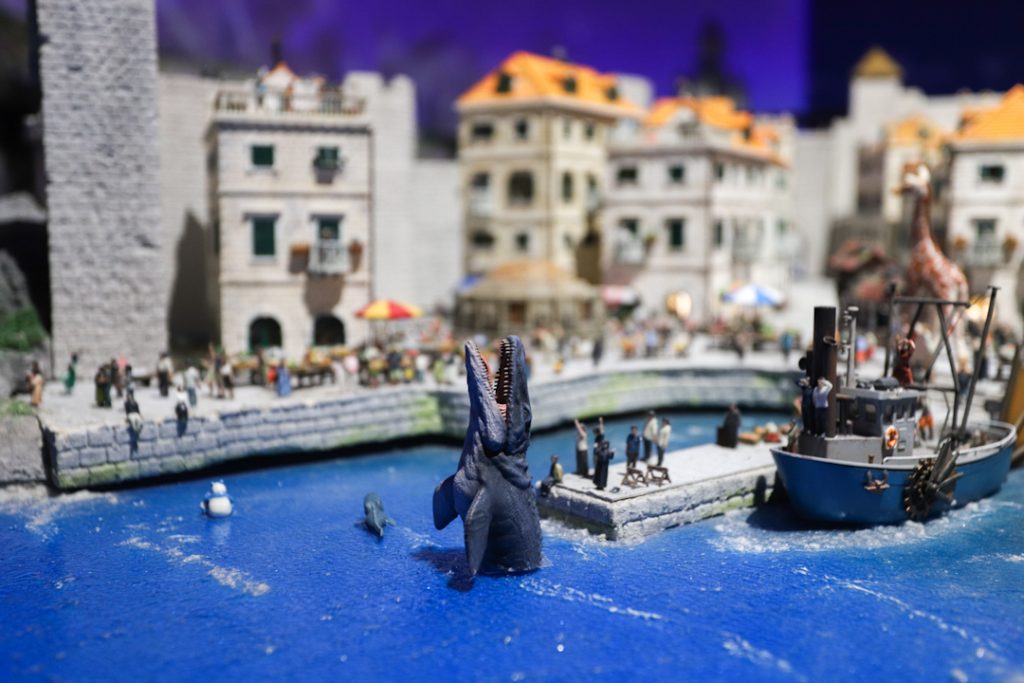 miniature port with a sea animal emerging from the sea