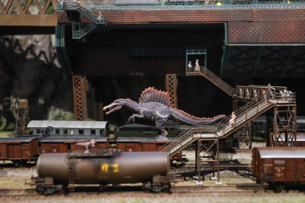 miniature train station with a dinosaur