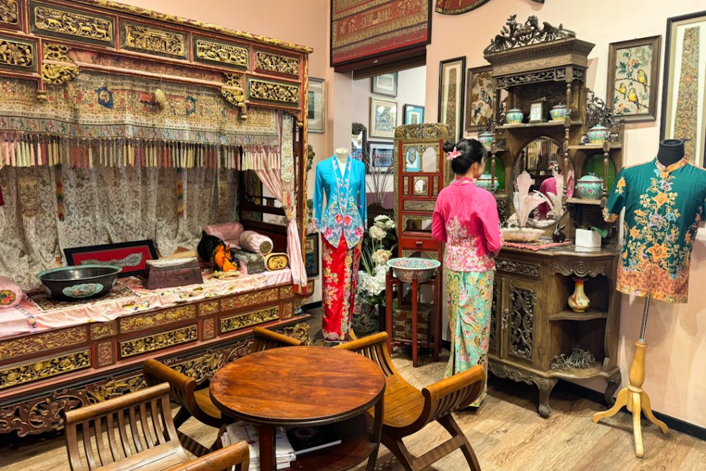 Woman wearing Peranakan kebaya and posing at Peranakan house in Singapore