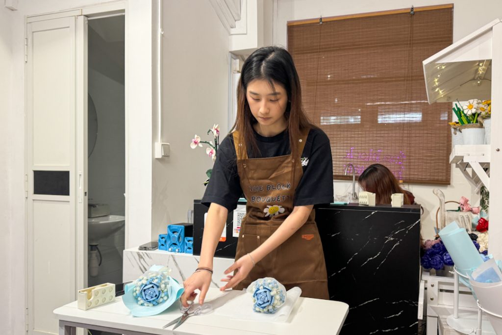 Instructor teaching how to fold bouquet flowers
