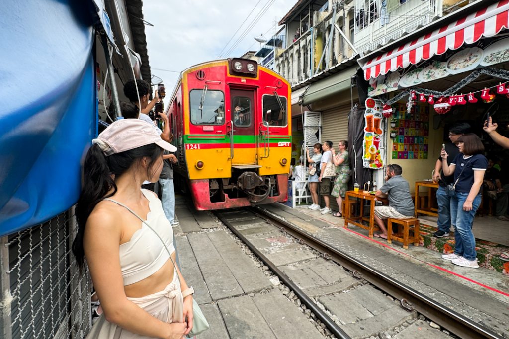 Train passing through the market at Maeklong Railway Market
