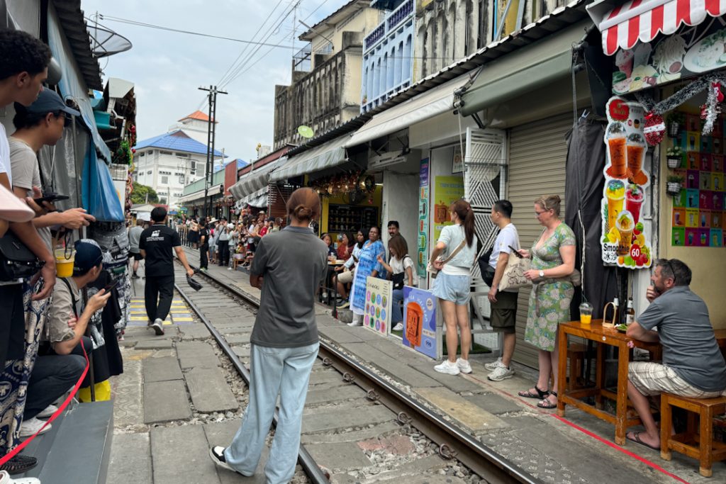 Best spot to wait for the train passing by at Maeklong Railway Market
