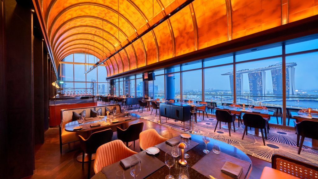 A stylish rooftop bar with high ceiling and modern ambience