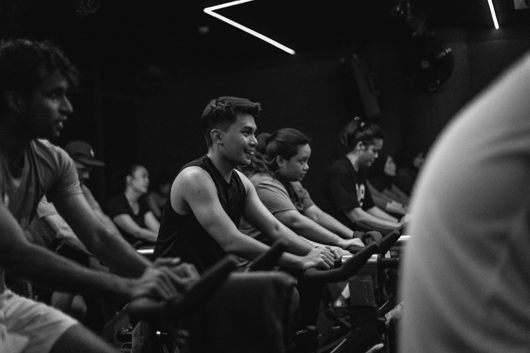 Dark spin cycling studio with mood lighting at Vibe Studio, Clarke Quay