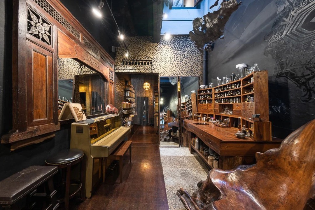 Interior of Sifr Aromatics with carved dark wood shelving and walls of perfume bottles