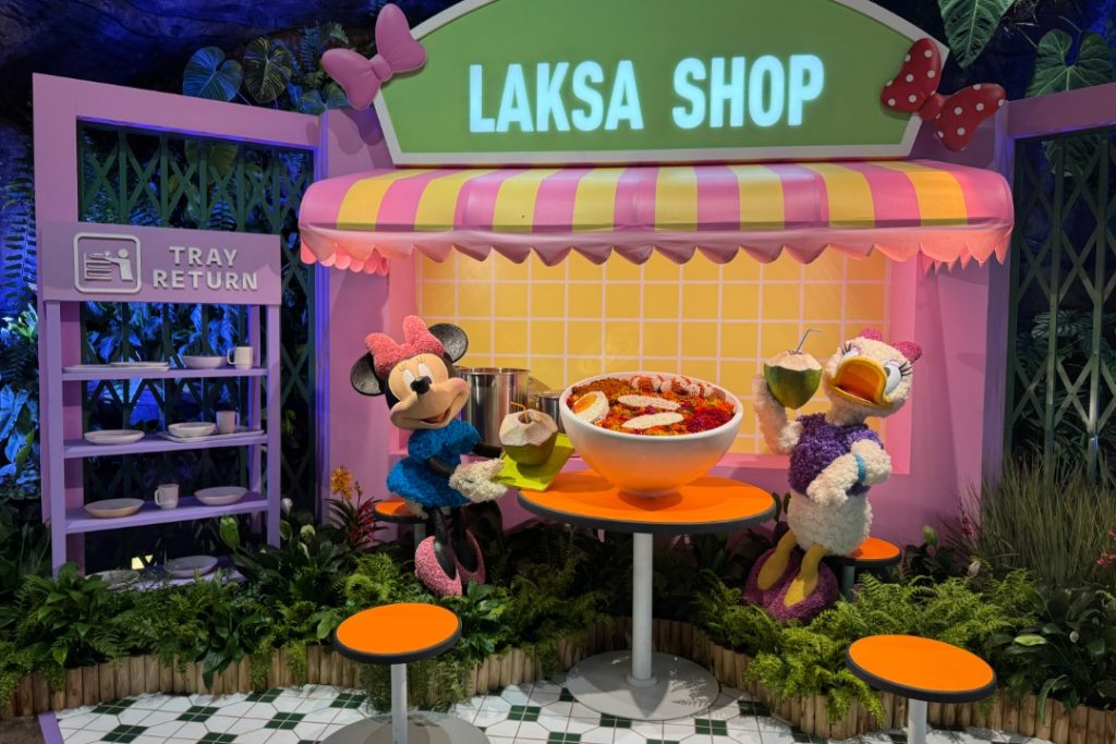 minnie mouse and daisy duck eating laksa at floral fantasy